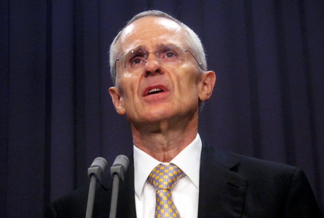 A man in a suit speaks.
