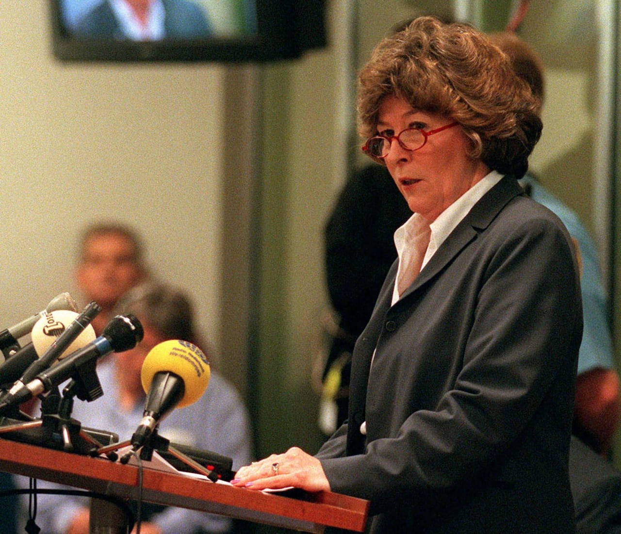 Arbour stands at a podium.