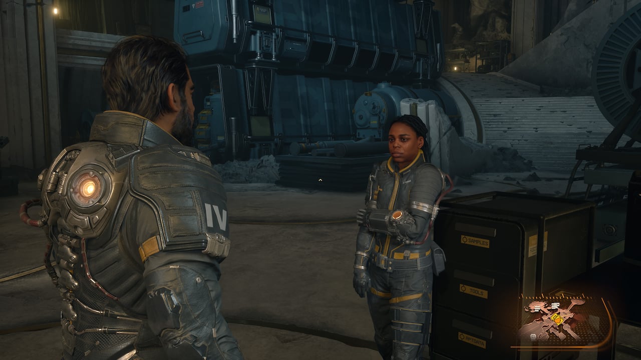 Video game screenshot of a man and woman speaking with one another. Both are wearing astronaut-like space suits.