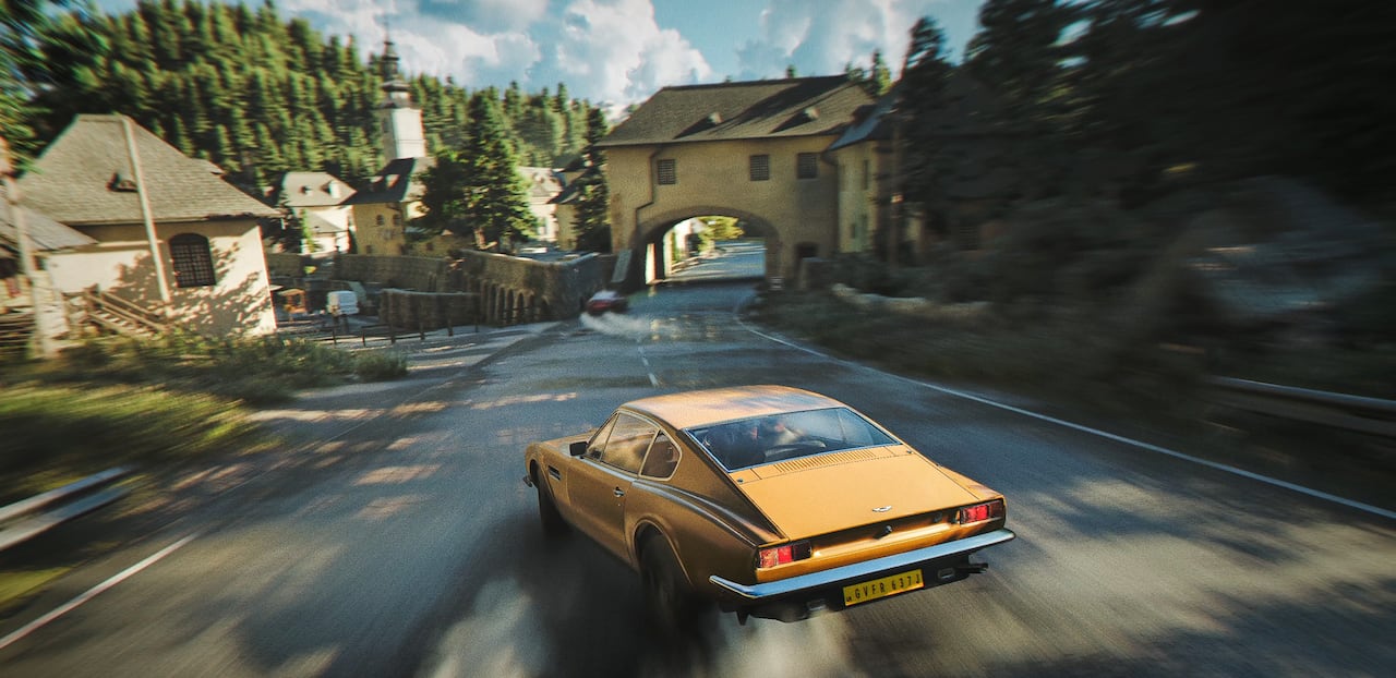 Video game screenshot of a car driving through a coastal European town.