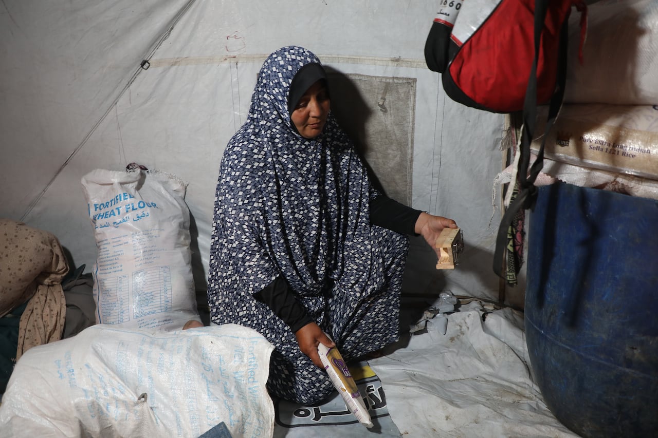 a woman in a veil sits in her tent