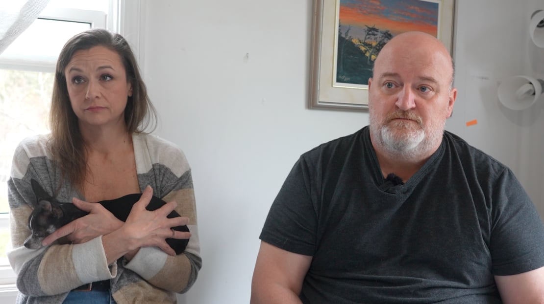 a couple sits at their kitchen table