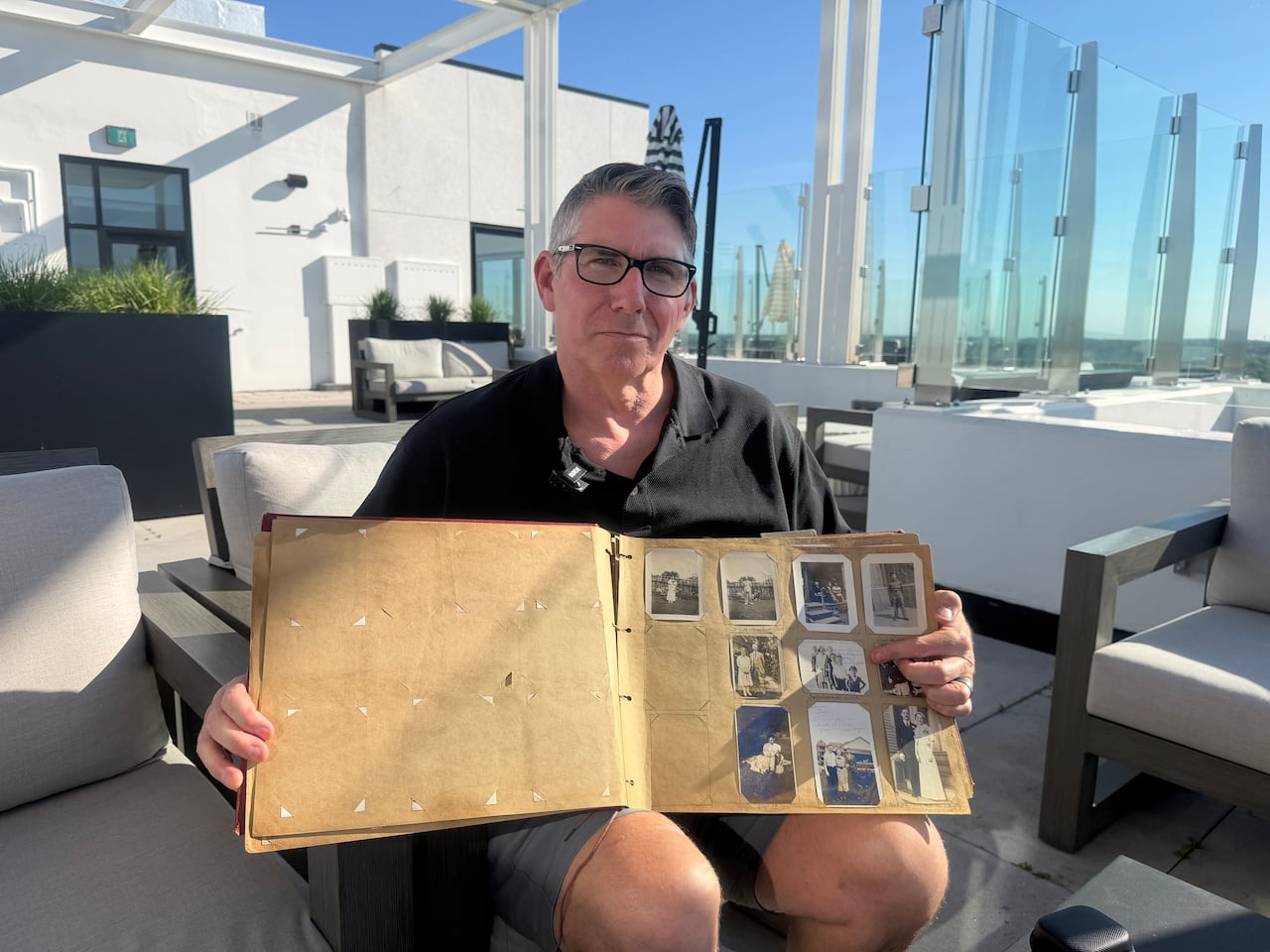 Aaron Powers holds his grandmother Audrey's photo album, which had countless photos of her half-brother Charles Slater.