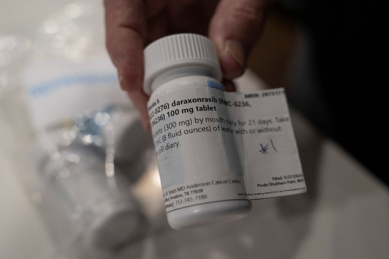 Menta "Steve" Wallace shows a bottle of daraxonrasib, Revolution Medicine's pancreatic cancer drug, at his home in The Woodlands, Texas, U.S.