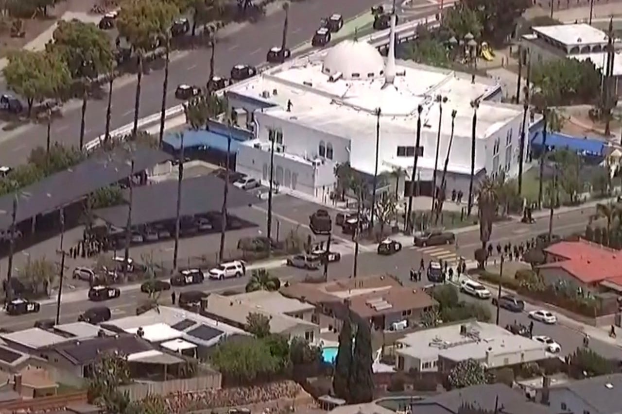 An aerial view shows police vehicles gathered near a mosque.