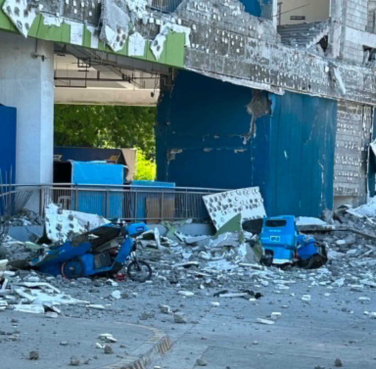 Debris is seen near a damaged building.