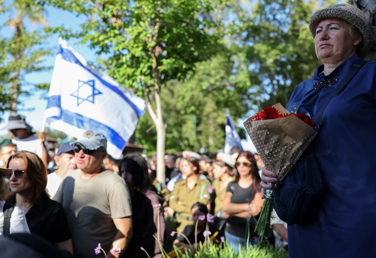 A woman holds flowers as people attend the funeral of Israeli soldier Staff Sergeant Michael Tyukin, who, according to the Israeli army, was killed in an explosive Hezbollah drone attack from Lebanon, in Ashkelon, Israel June 1, 2026.