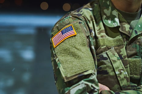 Cropped shot of a soldier wearing camouflage fatigues with an American flag for a patch.