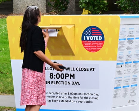 Woman slips envelope in yellow box